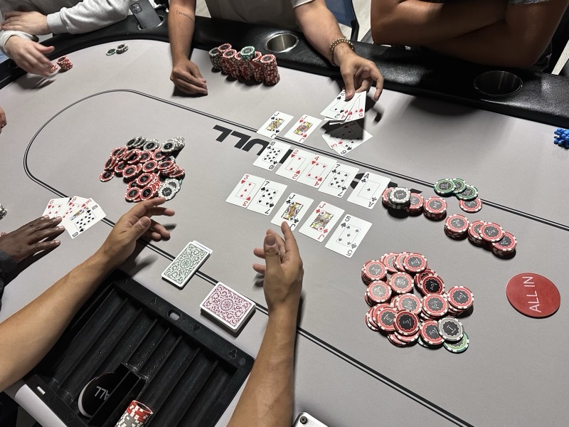 Live poker action on an Aces Full table